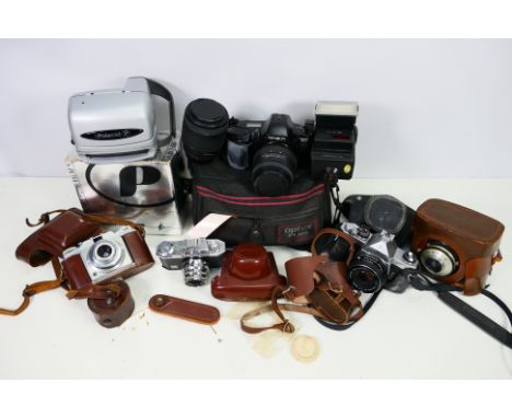 A collection of vintage cameras; a Polaroid Plus Film camera, a AGFA Clack Camera, a Pentax camera. All items are untested an
