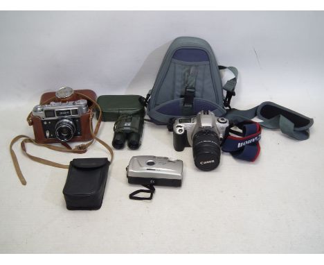 A collection of cameras and binoculars to includes; a Canon EOS 300 with bag among similar others. Items are untested. (JF).