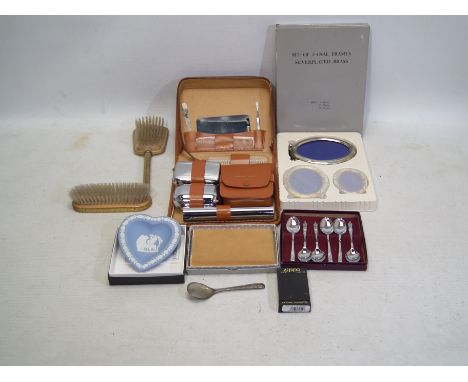 A collection to include; a boxed Zippo Lighter, a vanity set pair of brushes, a boxed set of chrome plated teaspoons, a boxed