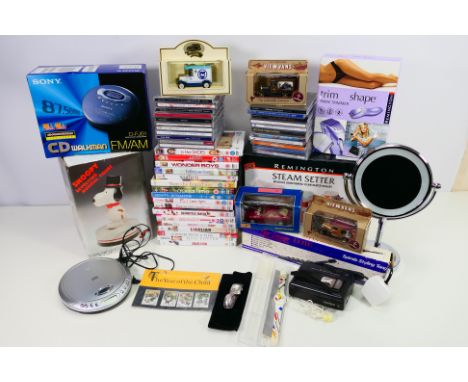A mixed lot to include vintage portable cassette and compact disc players, beauty products, small quantity of diecast, compac