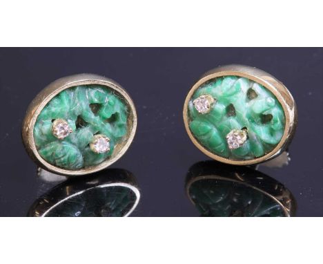 A pair of Continental carved jade and diamond gold earrings,with an oval carved and pierced jade plaque. Two eight cut diamon