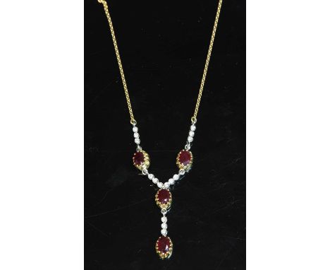An 18ct two colour gold ruby and diamond 'Y' necklace,with a centrepiece composed of four oval mixed cut rubies, each one cla