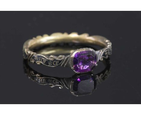 A Georgian gold amethyst memorial ring, c.1747,with a cushion-shaped flat cut foil-backed amethyst, in a cut down collet at t