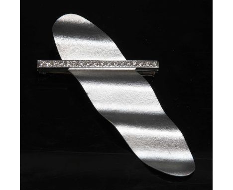 An Austrian white gold diamond set brooch,with an oval corrugated panel with a textured finish. A diagonal flat section bar, 