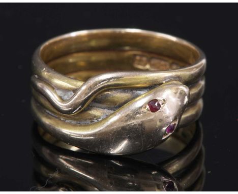 A Victorian 15ct gold ruby set snake or serpent ring,with a coiled snake with faceted ruby set eyes. Birmingham 1885. 10.68 t