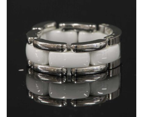 An 18ct white gold and white ceramic Chanel 'J12 Ultra' ring,with an arched head with incised Chanel signature. A central row