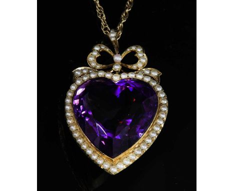 An Edwardian gold amethyst and split pearl pendant, c.1905,an heart-shaped, buff top, mixed cut amethyst, rub set to a frame 