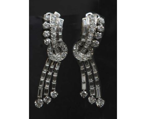 A pair of diamond set waterfall drop earrings, c.1940,of night and day style, with detachable pendant drops. Each earring com