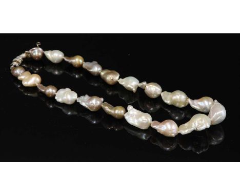 A single row graduated baroque cultured pearl necklace,with a white gold diamond set clasp. A single row of nineteen graduate