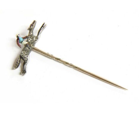 A diamond and enamel jockey stick pin,with a polychrome enamel jockey with a light blue body, maroon sleeves and white cap, r