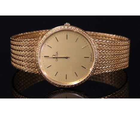 A gentlemen's 18ct gold Omega quartz bracelet watch,32mm case with a champagne dial, raised gilt batons and hands, textured b