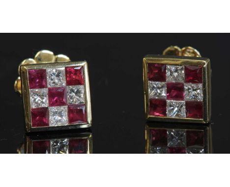 A pair of gold ruby and diamond chequerboard square cluster earrings,with five calibré princess cut rubies and four princess 