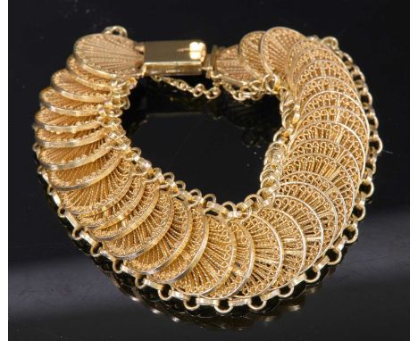 A Continental gold filigree bracelet,with a series of crescent fan-shaped links, all joined by two outer rows of oval links t