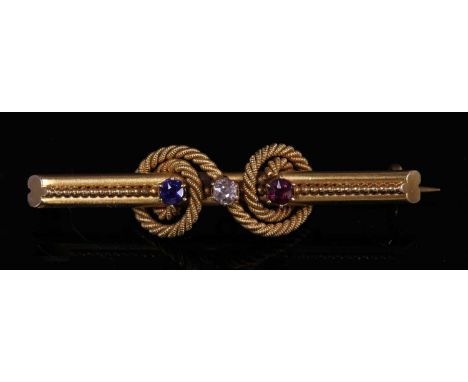 A Victorian gold diamond, sapphire and ruby bar brooch, c.1890,with an old Swiss cut diamond, claw set to the centre. A ruby 