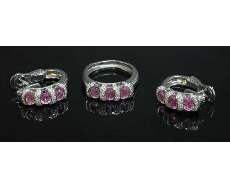 An 18ct white gold pink sapphire and diamond ring and earring suite,the three stone pink sapphire and diamond ring with an ov