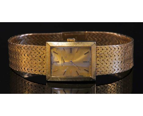 A ladies' 18ct gold Longines mechanical bracelet watch, c.1960,with a rectangular champagne dial, with raised gilt batons and