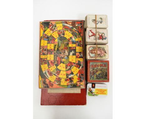 A boxed set of apothecary scales and a selection of early motor related board games 
