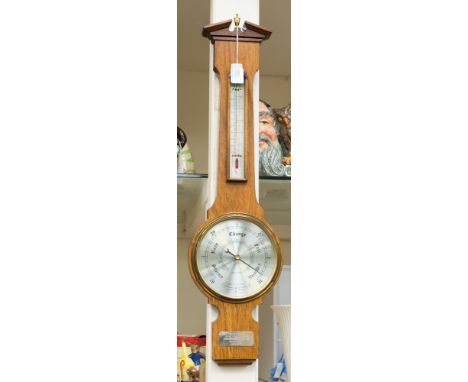 A 1979 oak cased Banjo barometer and thermometer, with a presentation plaque 