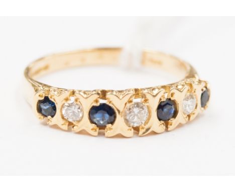 A sapphire and diamond set half hoop ring in all 18ct yellow gold shank with yellow claw setting, ring set with three round b