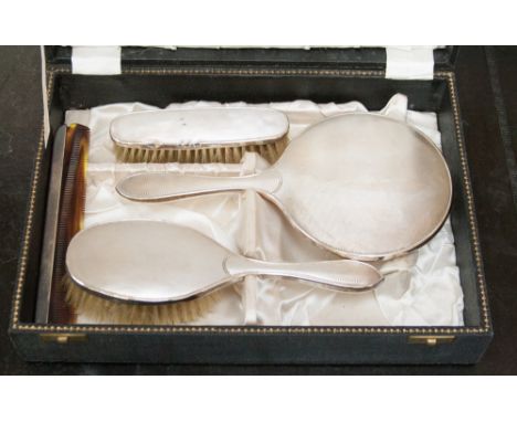 A four piece Birmingham 1929/30 dressing table set, engine turned decoration, boxed.