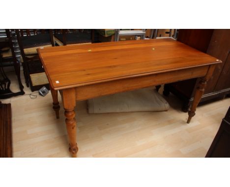 A Victorian style mahogany kitchen table, the plank top raised on turned tapestry legs, height 76cm x length 153cm x depth 75