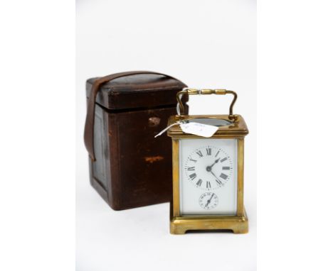 A gilt brass carriage clock, subsidiary seconds dial, with fitted key.