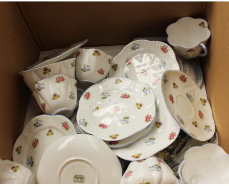 A Shelley tea service floral sprig decoration (21 pieces), six trios, bread and butter plate, cream jug and sugar bowl.