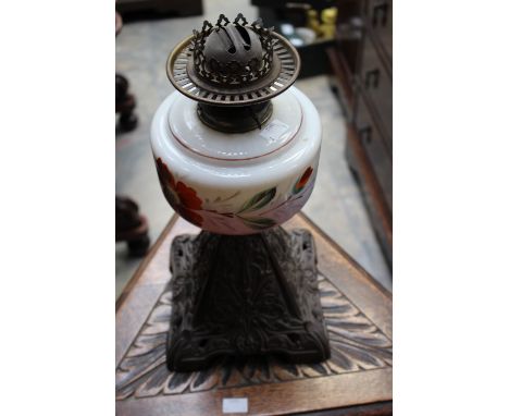 An Art Nouveau paraffin lamp, with an opaline glass hand painted reservoir, raised on a cast spelter base, approx 60 cm high 