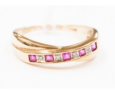 A 9ct ruby and diamond crossover ring channel set five rubies, alternated with diamonds 