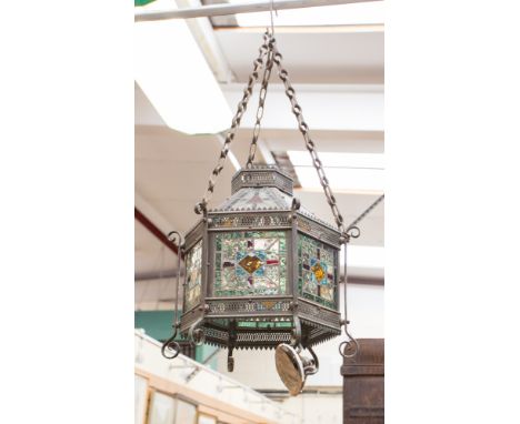 An early 20th Century stained glass light shade of hexagonal form, in the manner of Tiffany 