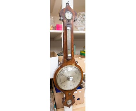 A 19th Century rosewood banjo barometer, by Bell and Dams, Uttoxeter, with a thermometer above circular barometer.