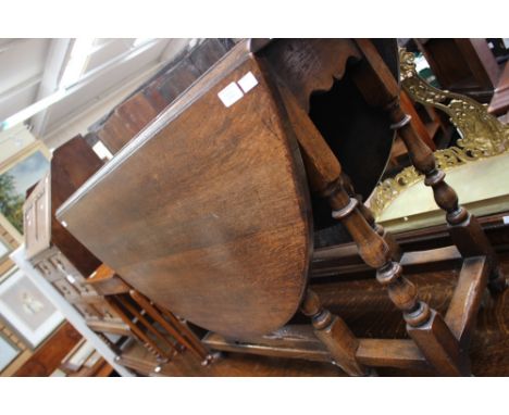 A 17th Century style oak gateleg table of pegged mortice abnd tenon construction, raised on baluster and ring turned legs, he