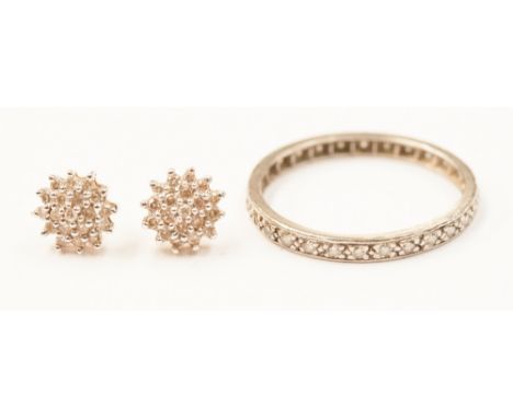 A diamond eternity ring and a pair of diamond cluster earrings 