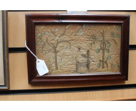 An early 19th Century small needlework panel depicting trees, birds, insects and animals including stag and squirrel on a sti