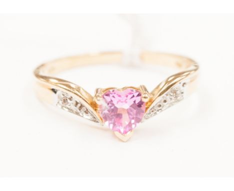 A 10ct gold ladies dress ring, set with a single pink stone, possibly a sapphire with diamond chip shoulders, ring size M and