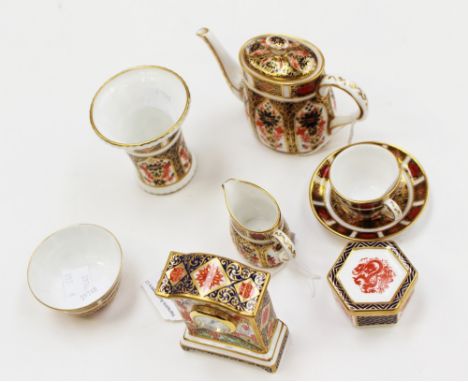 A collection of miniature Royal Crown Derby Imari, including Crown Derby 1128 coffee pot and cover, a Royal Crown Derby match