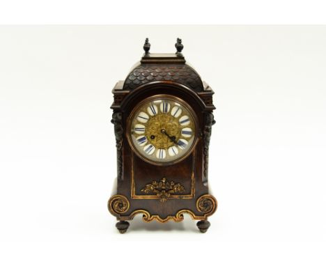 A late 19th Century walnut cased bracket clock, architectural top above gilt metal dial, inset with enamel Roman numerals, th