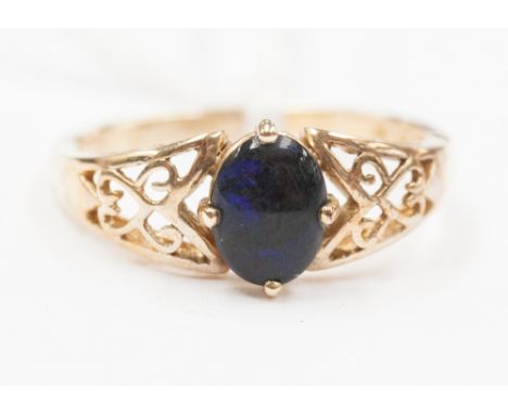 A blue/black opal, open weave design on shoulder, 9ct gold ring 