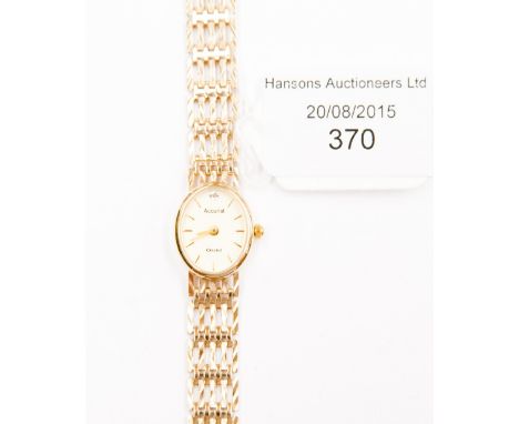A ladies wristwatch, an oval champagne coloured dial with gilt hands and batons, set with an 8 cut diamond to twelve o clock,