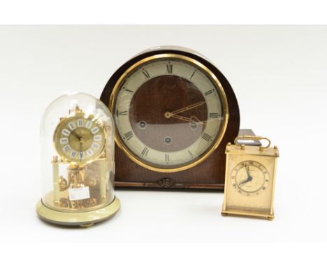 A 1930's oak dome top mantel clock, together with a quartz carriage clock, an anniversary clock (3)
