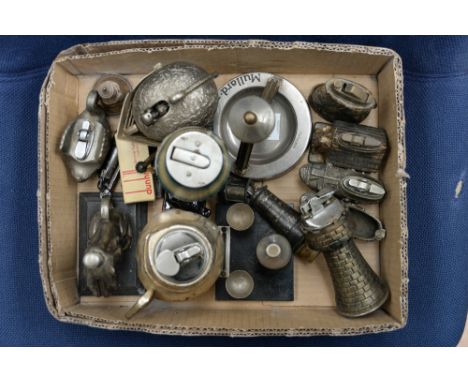 A collection of assorted novelty table lighters including a swan, dog in a kennel, seated dog, bottle and goblets, clogs, tab