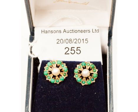 A pair of 9ct earrings decorated with a central pearl and emerald coloured opaque round polished stones, 