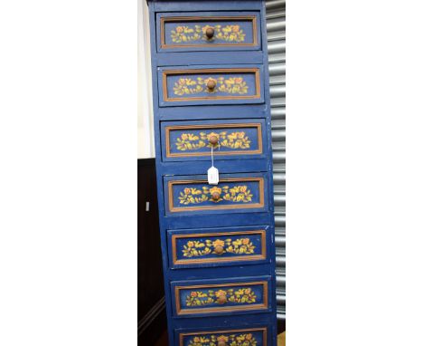 A folk style painted chest with seven drawers of small narrow proportions, hand decorated, together with a painted shelf and 