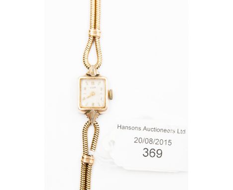 A ladies Tissot watch with 18ct gold snake strap 