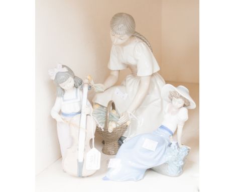 Three Nao Lladro figures including a girl with tulips, Cellist and girl with bird on rock (3) 