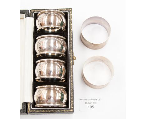 A boxed set of four silver napkin rings with a pair of engine turned silver napkin rings, weighing a total of approx 112.7 gr