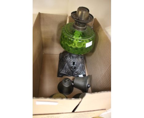 A late 19th Century cast iron oil lamp FS and Co Ltd, with green glass bowl; together with four brass 'shop' type bells (5) 