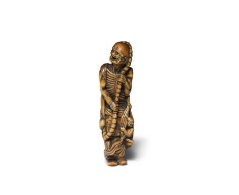A WOOD NETSUKE OF A RAKAN (DISCIPLE OF BUDDHA)Edo period (1615-1868), probably 18th centuryUnusually represented, standing wi