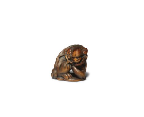 ISSAIA Wood Netsuke of a Shishi (Chinese Mythical Lion) Edo period (1615-1868), 19th centurySeated, its head turned to the ri