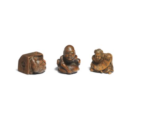 THREE WOOD NETSUKEEdo period (1615-1868), 19th centuryComprising a blind masseur lifting a huge stone, signed Masakazu, 4cm (